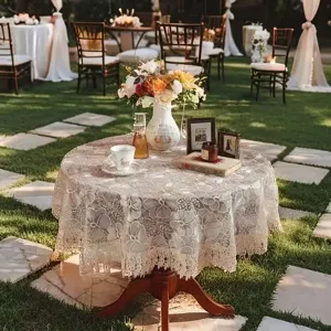 Elegant lace round tablecloth with delicate floral embroidery, perfect for dining and tea tables.