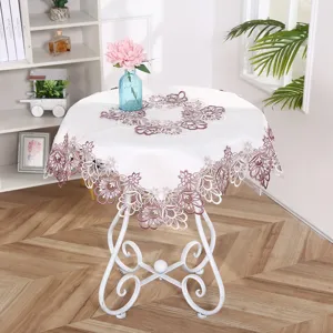 Close-up details of the elegant white and purple lace embroidery tablecloth showing exquisite craftsmanship.