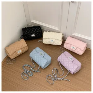 Detailed view showing multiple colorful quilted chain shoulder bags neatly arranged on a wooden floor.