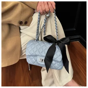Light blue quilted chain shoulder bag with black bow detail, stylish crossbody small square bag.