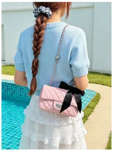Stylish pink quilted chain shoulder bag with cute black bow accent for women and girls daily wear.