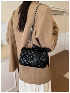 Chic black quilted chain shoulder bag with elegant bowknot, premium crossbody bag.