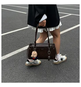 Large capacity brown shoulder tote bag with cute bear pendant for daily commute and fashion wear.