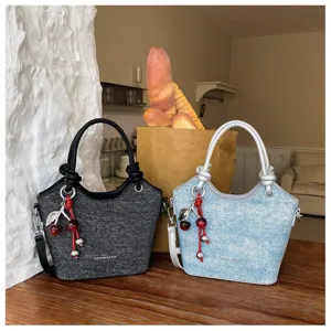 Stylish casual bucket bag with cherry charm and knotted handle, perfect for daily commuting use.