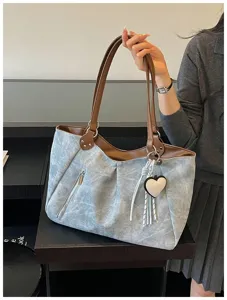 Korean style large capacity shoulder tote bag with washed texture, brown handles and heart pendant.