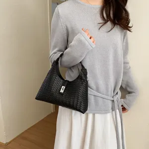 Classic black woven shoulder bag for women, stylish minimalist hobo handbag with metal lock.