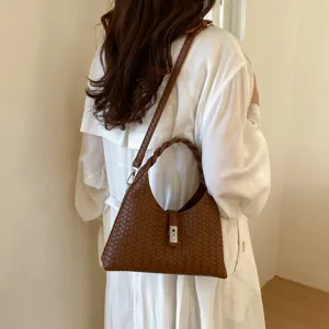Women brown woven shoulder bag, elegant hobo purse with braided handle for daily commute.