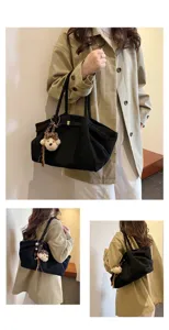 Stylish large capacity black canvas tote bag for women daily commute with cute bear pendant.