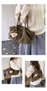 Detailed view showcasing the dark green suede tote bag with a cute bear pendant and spacious build.