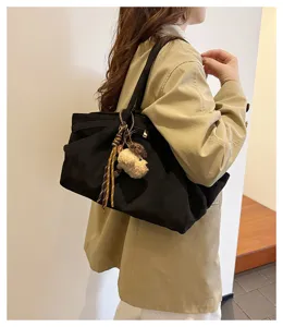 Women large capacity black canvas tote bag fashion casual shoulder bag with cute plush pendant.