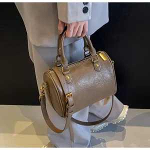 Brown boston pillow bag detail view, chic PU leather handbag with shoulder strap for daily wear.