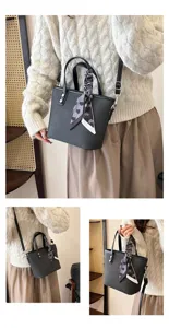 Chic black woven bucket bag with stylish scarf handle, perfect for casual daily wear and summer outfits.