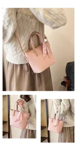 Detail view of pink woven crossbody bag with cute heart ribbon strap for women daily wear.