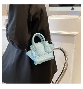 Light blue mini leather crossbody bag with chain strap, stylish trendy handbag for women.