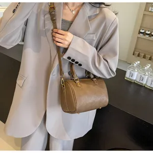 Chic brown leather Boston bag for women, versatile crossbody and shoulder handbag style.