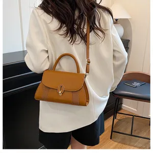 Brown top-handle shoulder bag for women, stylish niche design handbag with metal lock.