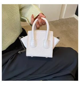 White mini handbag with snake skin texture, top handle and chain strap for women.