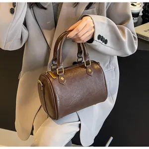 Classic brown Boston handbag detail view, stylish commuter shoulder bag for women.