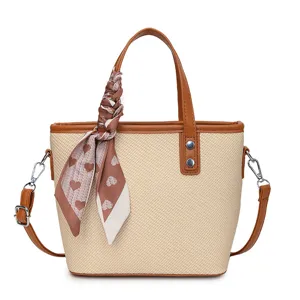 Trendy straw tote bag for women with PU leather trim, crossbody strap, and chic heart scarf.