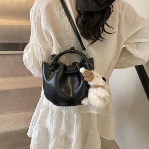 Women fashion retro bucket bag PU leather casual shoulder crossbody handbag with cute puppy charm.