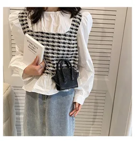 Detailed view of fashionable black mini crossbody bag with woven texture, ideal for everyday.