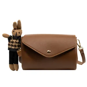 Brown cylinder crossbody bag for women with cute knitted rabbit charm stylish purse