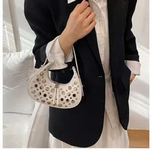 White studded crescent shoulder bag detail, stylish punk style underarm handbag for women.