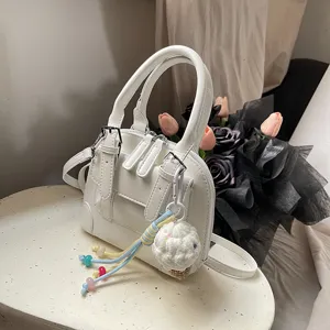 Korean vintage style white handbag for women, PU leather shoulder crossbody bag with cute charm.