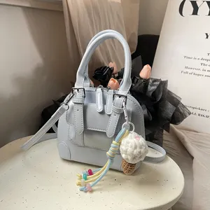 Light blue mini shoulder bag for women, PU leather retro crossbody handbag with cute charm.