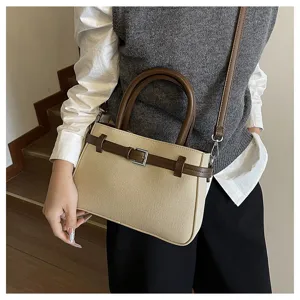 Detail shot of vintage contrast color women handbag, stylish crossbody commute bag for daily use.