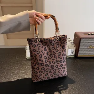 Chic leopard print handbag with bamboo handle, casual retro shoulder bag for women daily commute.