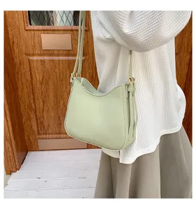 Minimalist light green bucket shoulder bag, casual everyday fashion handbag detail view.