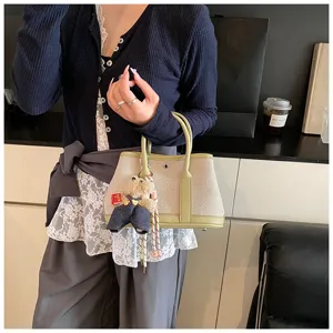 Chic canvas tote bag for women with leather contrast trim and cute bear keychain, large capacity.