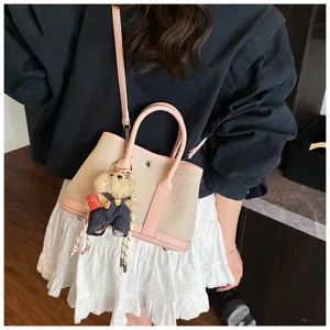 Canvas pink leather handbag tote bag with cute bear pendant, stylish shoulder crossbody bag.