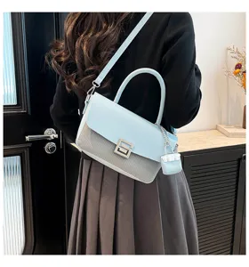 Stylish women's light blue shoulder crossbody handbag with elegant metal lock and charm.