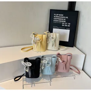 Mini vertical bucket bag for women, cute crossbody phone bag with pearl bow, daily compact purse.
