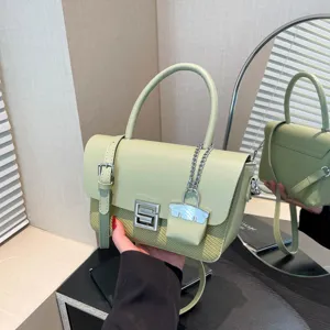 Stylish light green leather crossbody bag for women, retro commuter shoulder bag with silver hardware.