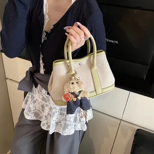 Stylish canvas tote handbag for women with cute bear charm, large capacity colorblock design.