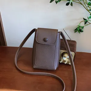 Stylish PU leather mini crossbody phone bag for women, retro brown shoulder pouch purse.
