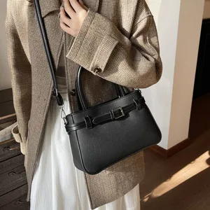 Elegant black top handle handbag for women, chic commuting crossbody bag with belt detail.