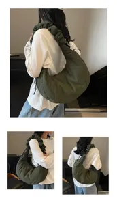 Detail view of dark green nylon cloud bag, featuring stylish pleated strap and large capacity.