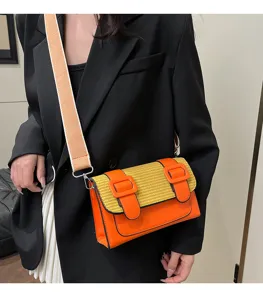 Stylish color-block crossbody bag with wide strap and double buckle design for women daily use.