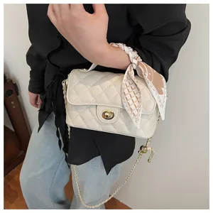 Quilted shoulder bag detail, elegant off-white design with chic chain strap and cute twilly scarf.