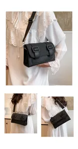 Chic black shoulder bag for women, stylish crossbody satchel with wide strap and buckle details.