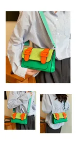 Detail view of stylish colorblock satchel bag worn by model, showing versatile crossbody wear.