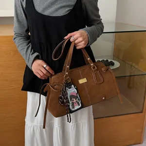 Retro matte Boston shoulder bag for women, large capacity commuter handbag with chic pendant.