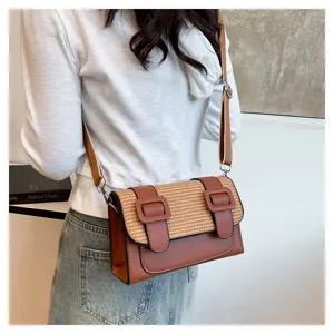 Detailed view of the stylish color-block straw woven satchel shoulder bag with double buckles.