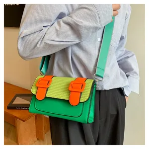 Stylish color block crossbody bag featuring patchwork design and wide strap for daily commute.