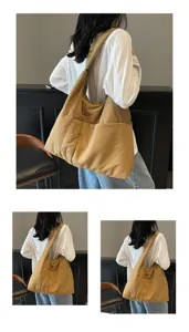 Detail view of the soft quilted shoulder bag showing spacious capacity and wide strap.