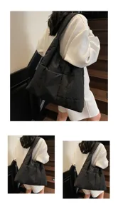 Detailed view of the large capacity black puffer shoulder bag, featuring soft quilted fabric.